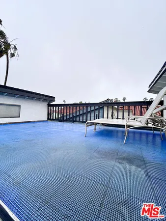 an aerial view of a house with a yard and a fountain
