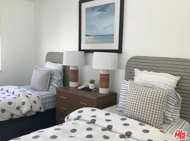 a bedroom with a bed and a lamp