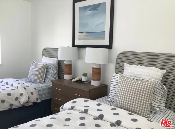 a bedroom with a bed and a lamp