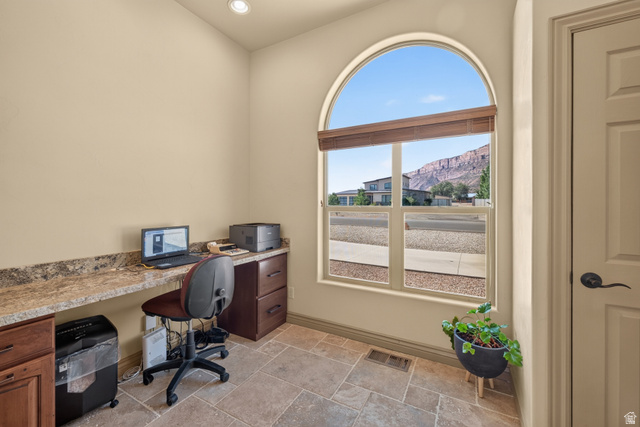 4635 East Sunny Acres Lane Moab, UT 84532 - Photo 30 of 56 Room featuring a large arched window with horizontal blinds, providing natural light