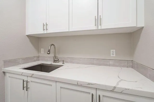 a view of a swimming pool with lawn chairs and a big yard