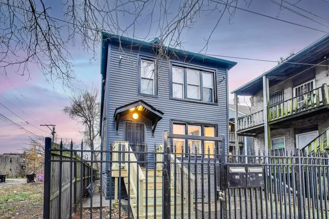 a front view of a house with a iron gate