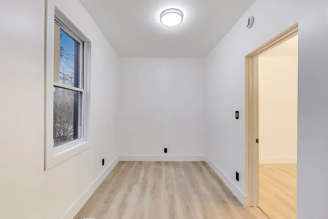 a view of room with window and hardwood floor