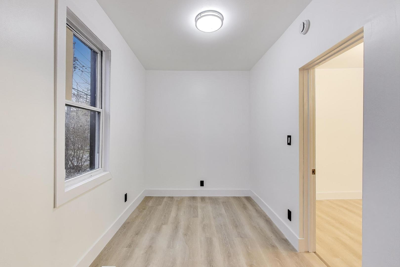 1117 West 57th Street Chicago, IL 60621 - Photo 14 of 24 a view of room with window and hardwood floor
