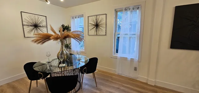 a view of a dining room with furniture and wooden floor