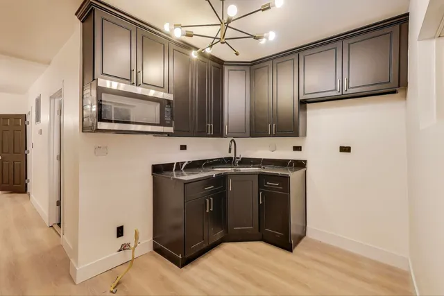 a kitchen with stainless steel appliances granite countertop a refrigerator and a stove top oven