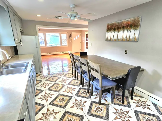 a view of a dining room with furniture and chandelier