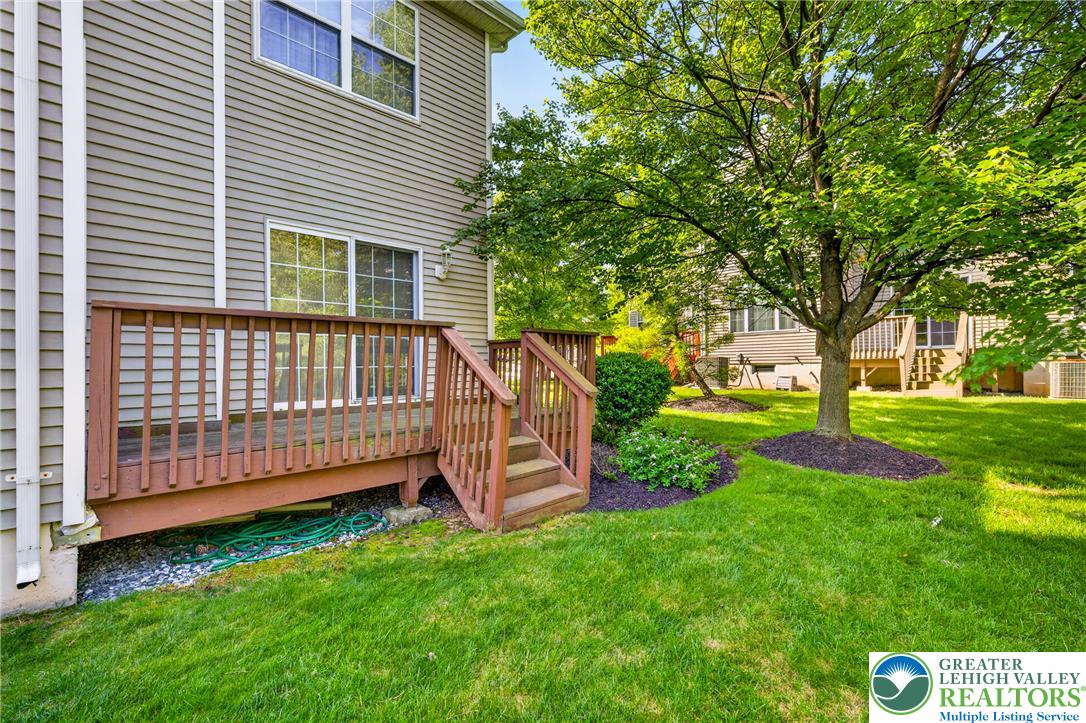 4345 Creek Road Allentown, PA 18104 - Photo 28 of 33 A welcoming rear deck extends into a verdant lawn, ideal for outdoor gatherings.