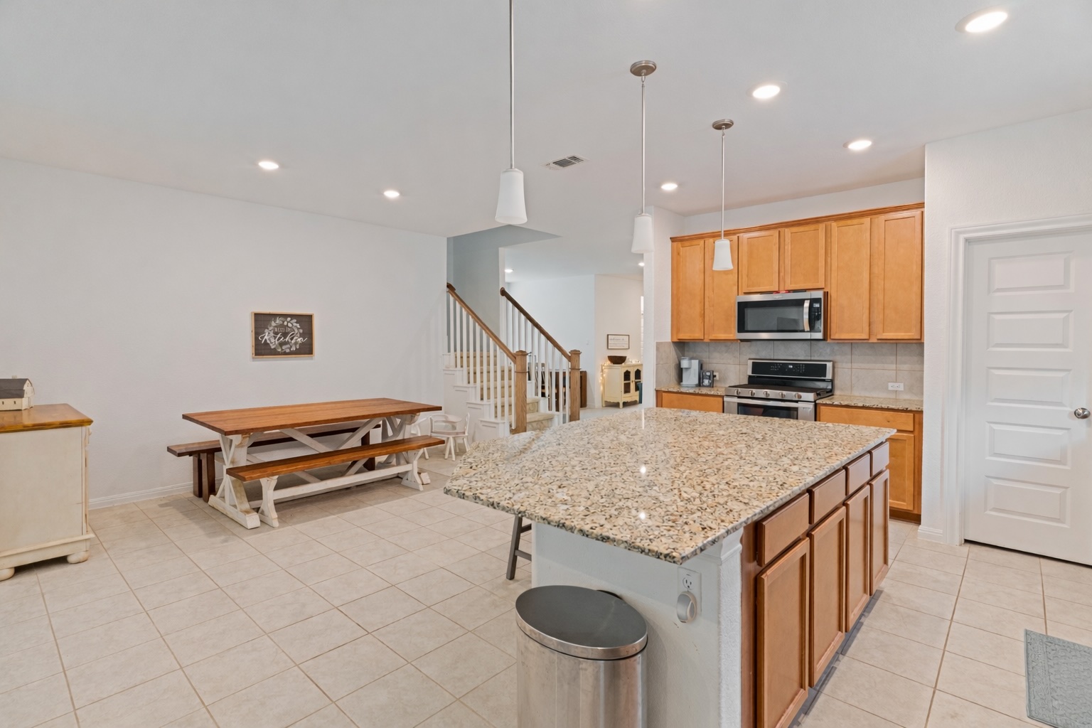 237 Rain Lily Lane Georgetown, TX 78626 - Photo 12 of 20 a kitchen with stainless steel appliances granite countertop a sink and a refrigerator