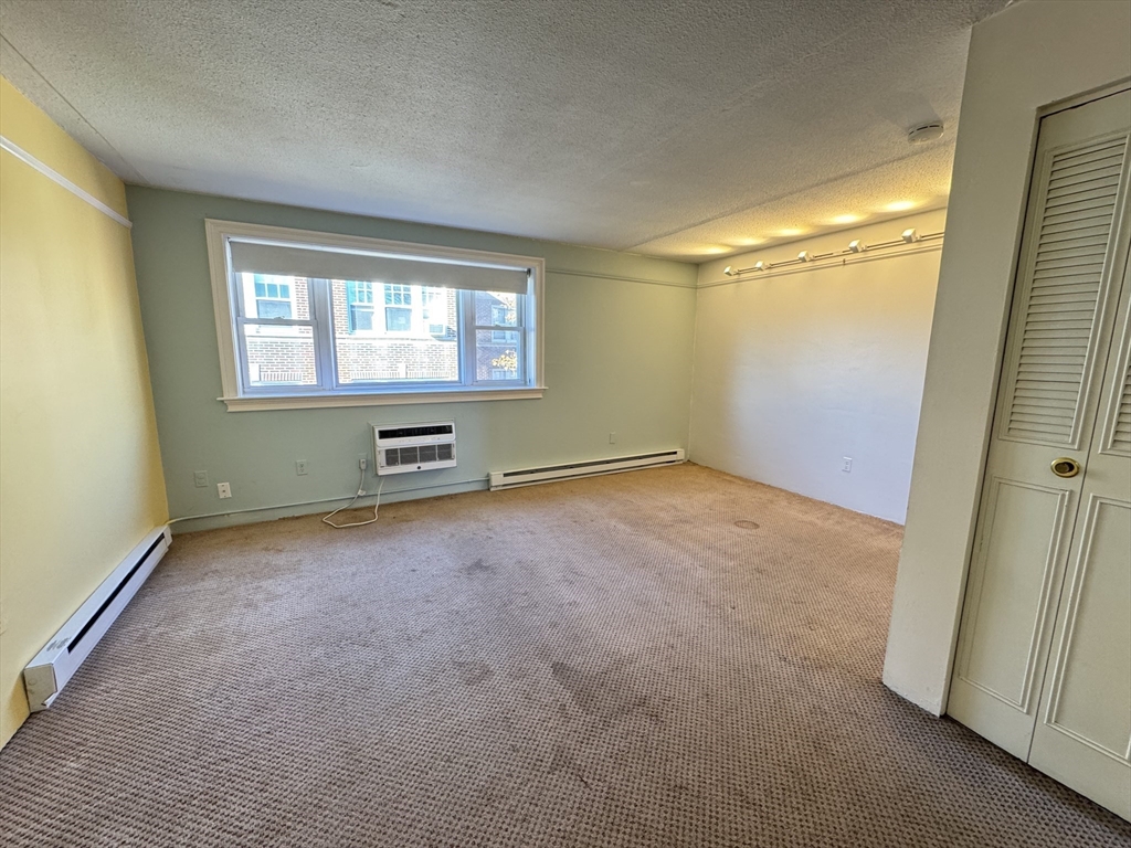 1691 Cambridge Street, Unit 42 Cambridge, MA 02138 - Photo 6 of 16 an empty room with windows