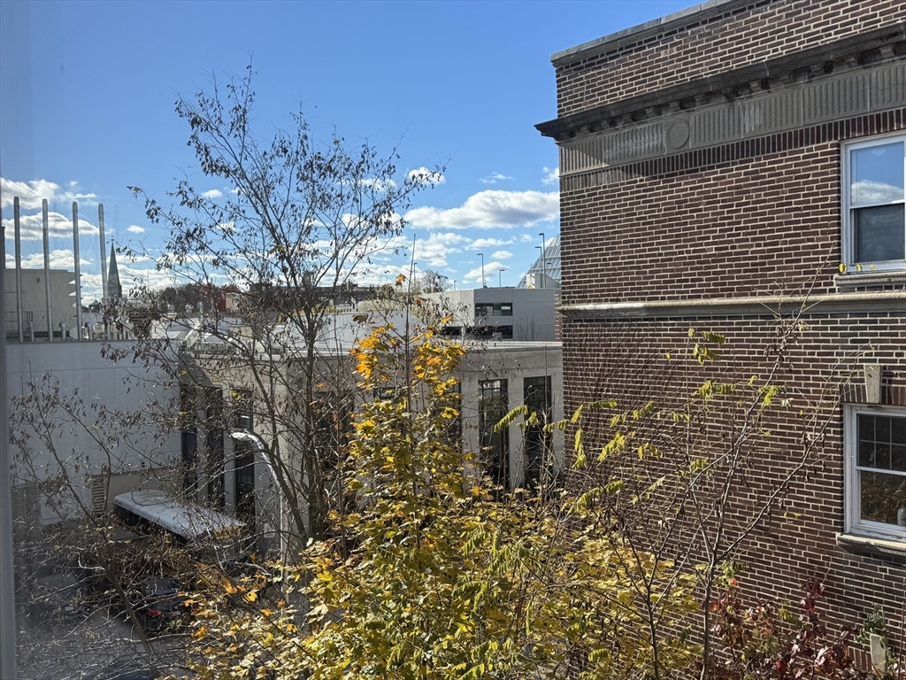 1691 Cambridge Street, Unit 42 Cambridge, MA 02138 - Photo 8 of 16 a view of a house with a tree