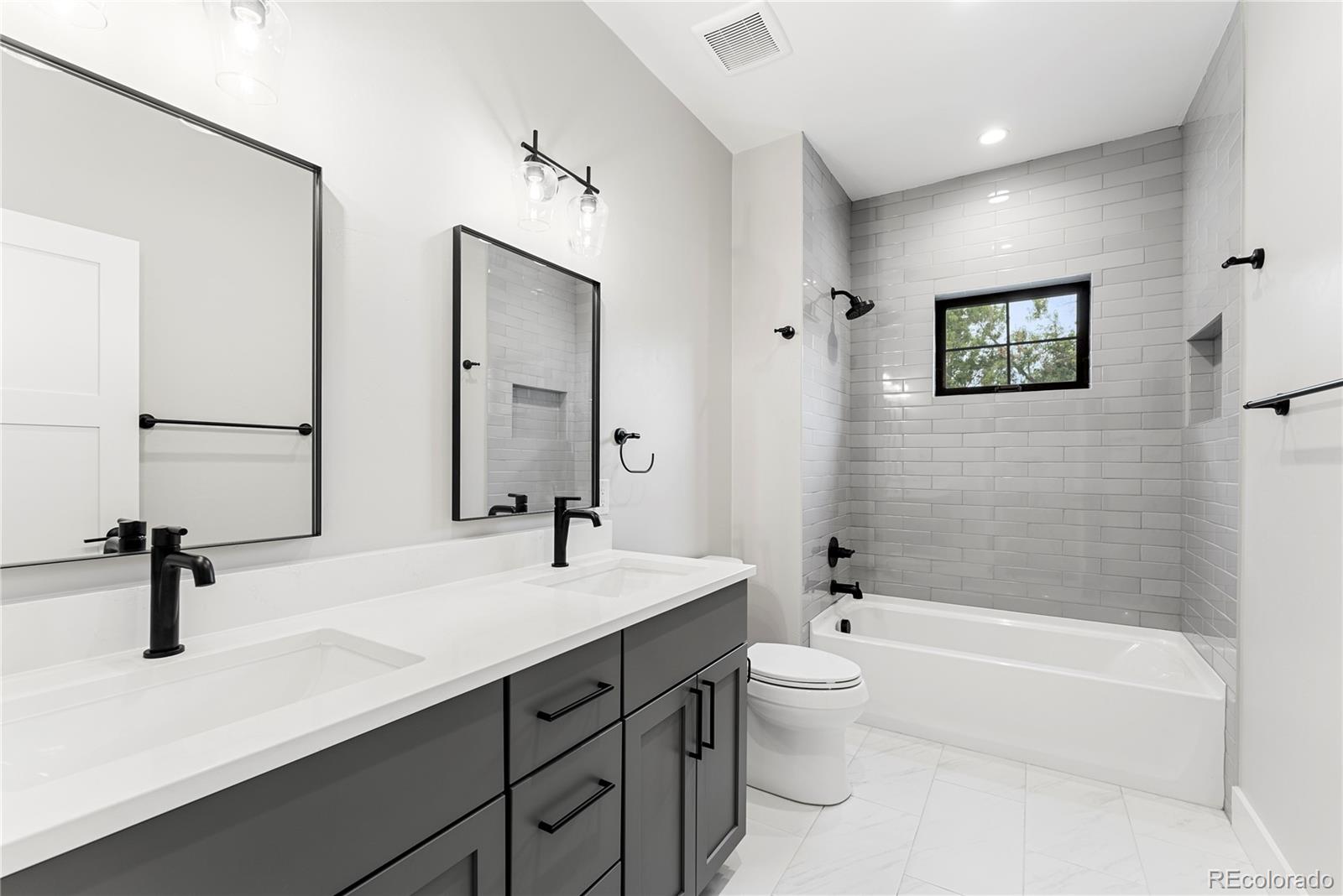 4494 Meade Street Denver, CO 80211 - Photo 12 of 36 a bathroom with a sink a toilet and a tub