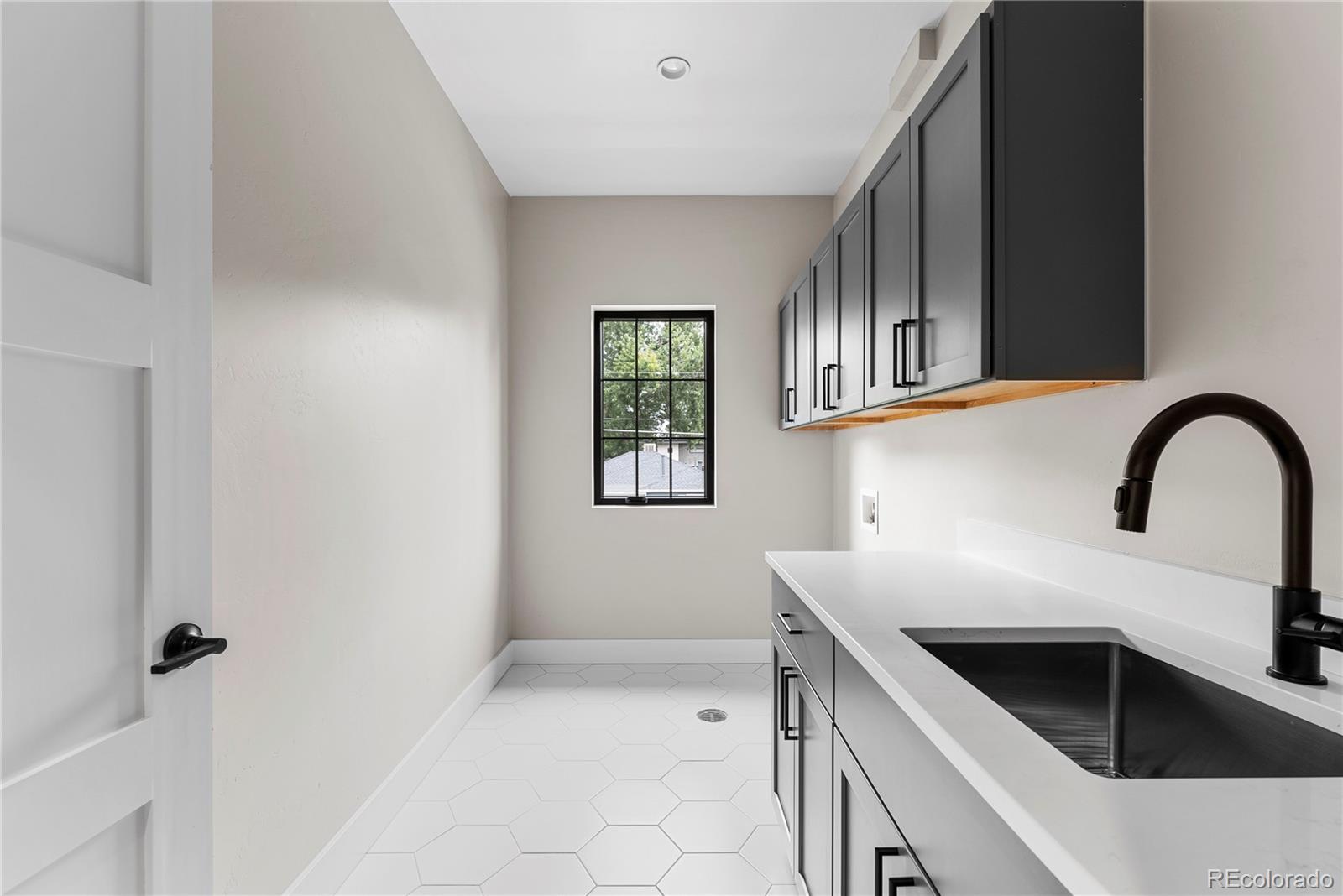 4494 Meade Street Denver, CO 80211 - Photo 14 of 36 a kitchen with a sink and cabinets