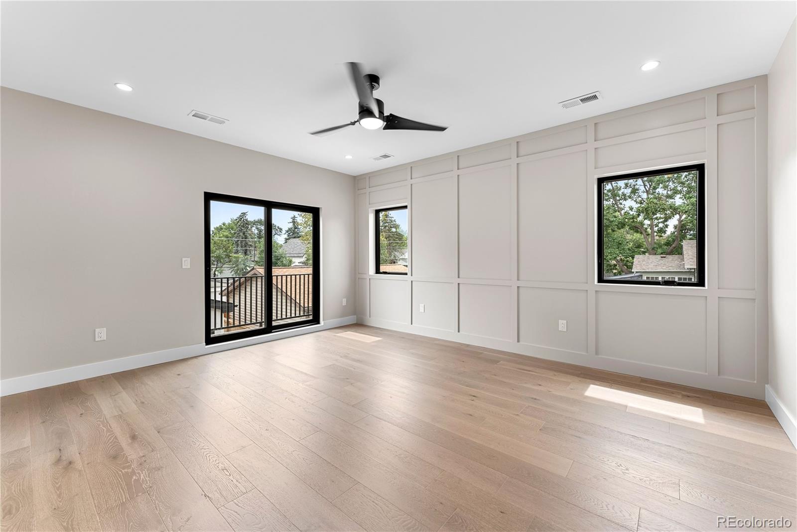 4494 Meade Street Denver, CO 80211 - Photo 17 of 36 a view of an empty room with a window and wooden floor