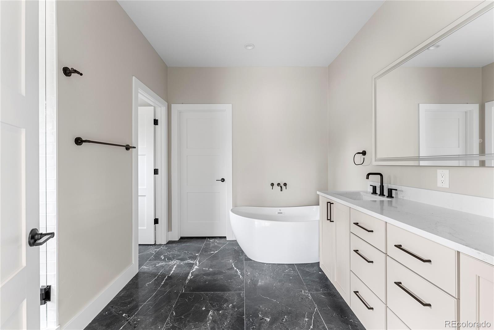 4494 Meade Street Denver, CO 80211 - Photo 20 of 36 a large white bathroom with a bathtub sink and mirror