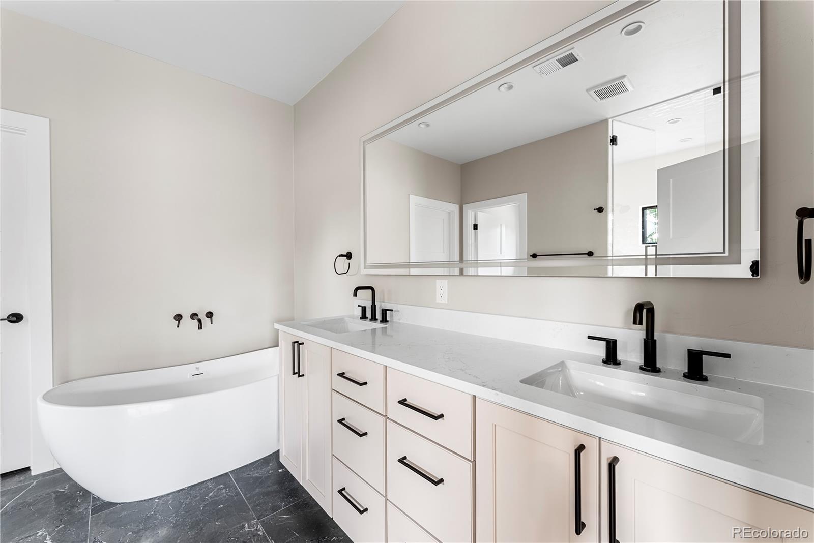 4494 Meade Street Denver, CO 80211 - Photo 21 of 36 a kitchen with white cabinets and sink