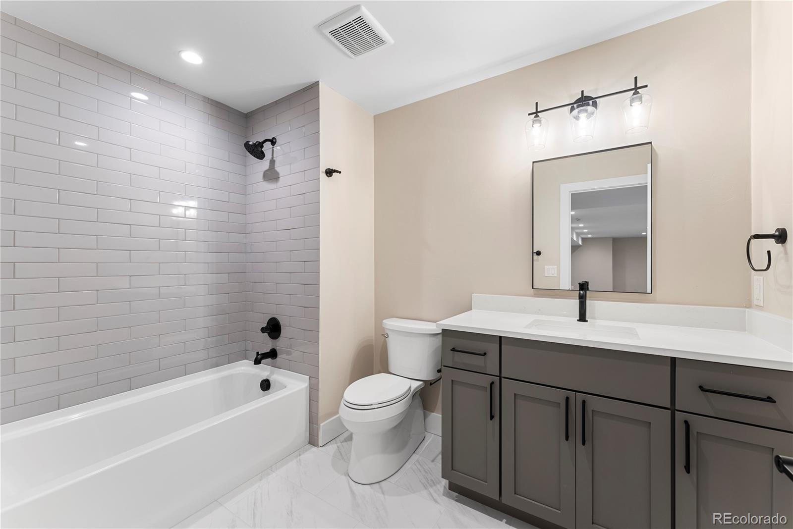 4494 Meade Street Denver, CO 80211 - Photo 25 of 36 a bathroom with a sink a toilet and a bathtub