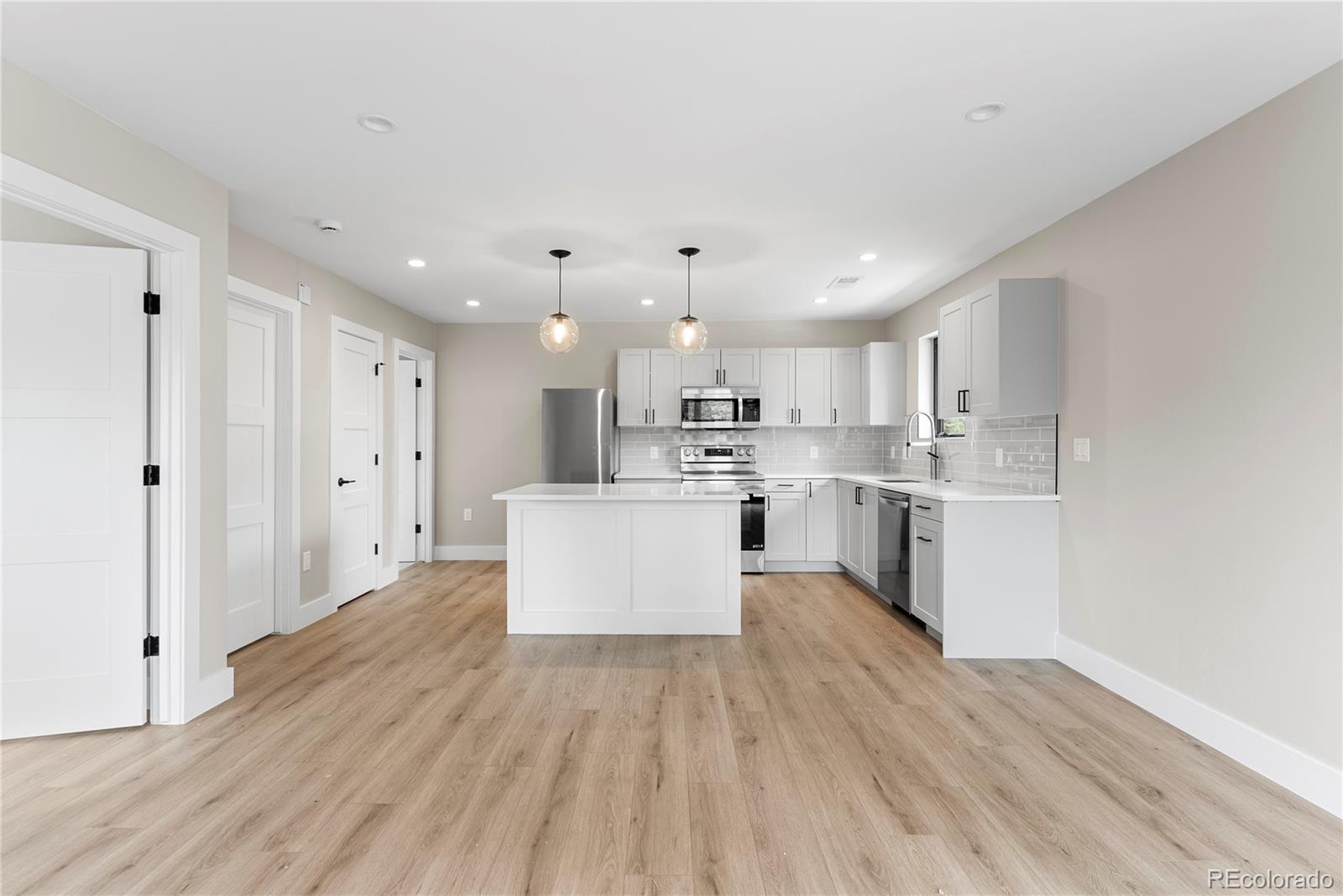 4494 Meade Street Denver, CO 80211 - Photo 28 of 36 a large kitchen with a lot of counter space and a refrigerator