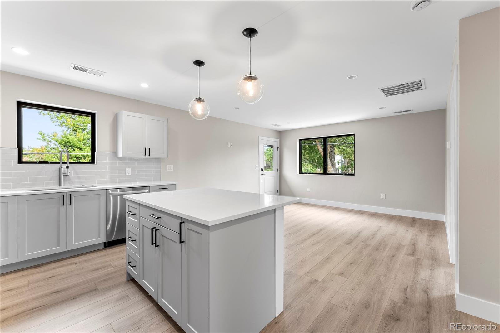 4494 Meade Street Denver, CO 80211 - Photo 31 of 36 a kitchen with a sink stove and wooden floor
