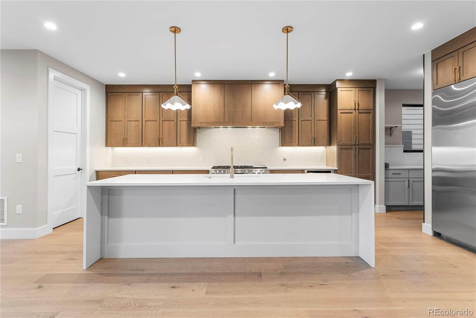4494 Meade Street Denver, CO 80211 - Photo 4 of 36 a kitchen with a refrigerator and a sink