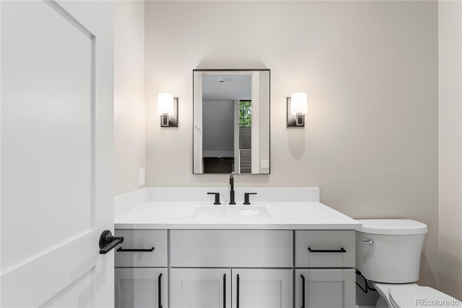 4494 Meade Street Denver, CO 80211 - Photo 9 of 36 a bathroom with a sink mirror and toilet