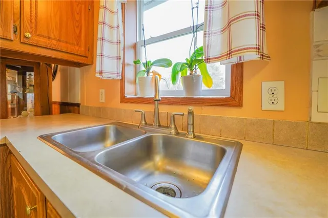 a view of a kitchen with a refrigerator and a sink