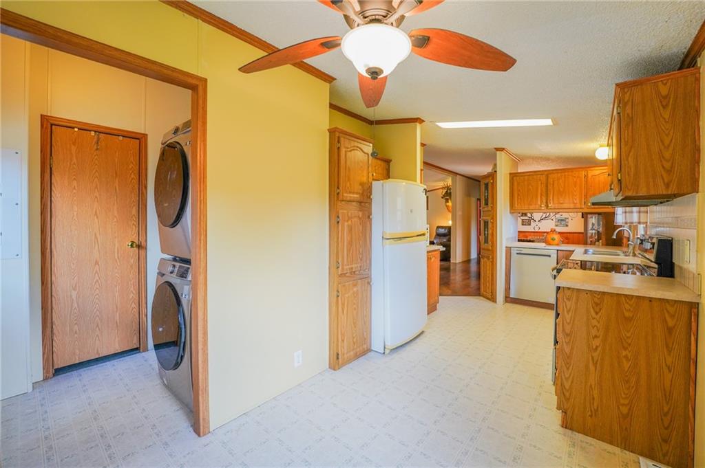 204 Hollowvue Road Wampum, PA 16157 - Photo 18 of 46 a view of a kitchen with a refrigerator and a sink