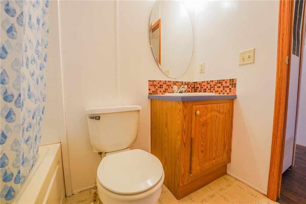 204 Hollowvue Road Wampum, PA 16157 - Photo 27 of 46 a bathroom with a toilet and a shower curtain