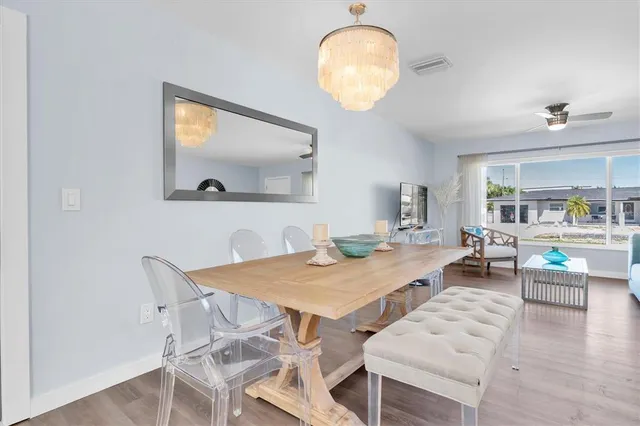 a view of a dining room with furniture and a chandelier