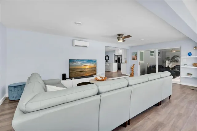 a living room with couch and a floor to ceiling window
