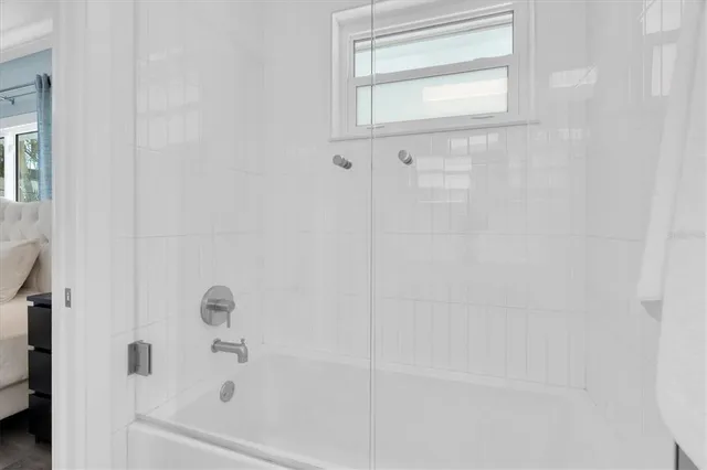 a bedroom with bed and a window