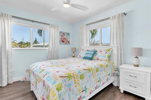 a bedroom with a bed and painting on the wall