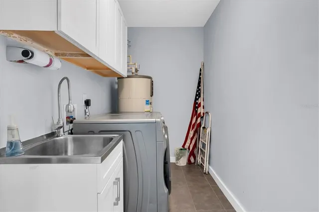 a living room with couches a coffee table and with kitchen view