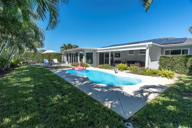 a backyard of a house with yard fountain and outdoor seating