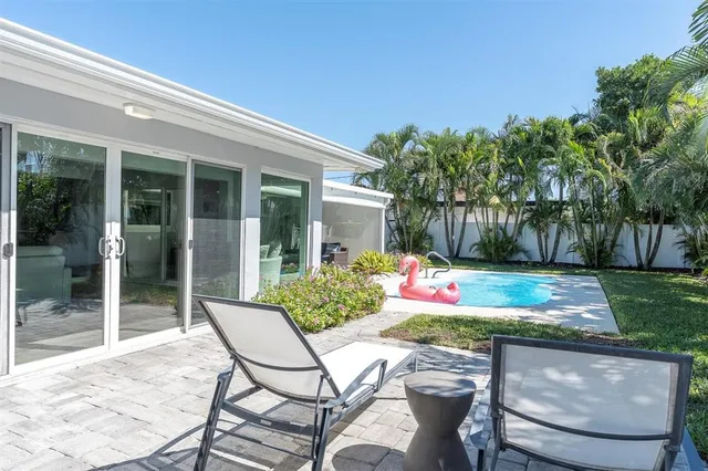 a view of a chairs and table in backyard