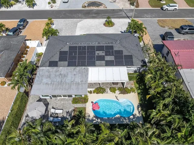 a view of patio with table and chairs under an umbrella