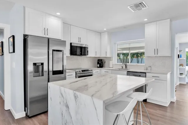 a kitchen with a sink stove and refrigerator