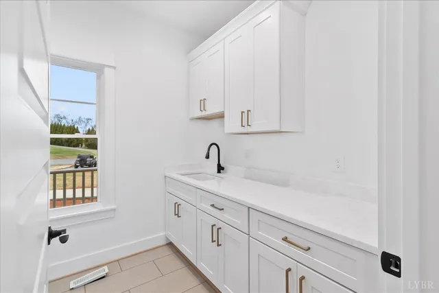 a kitchen with granite countertop a sink stainless steel appliances and cabinets