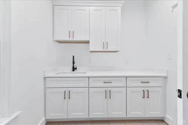 a kitchen with white cabinets and white appliances
