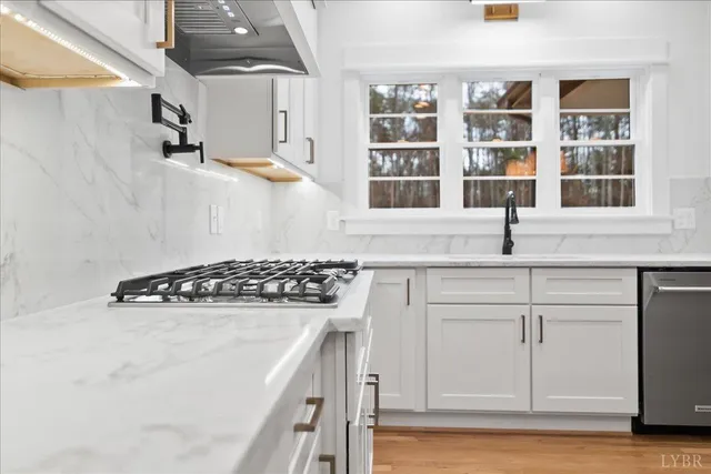 a kitchen with cabinets appliances and a window
