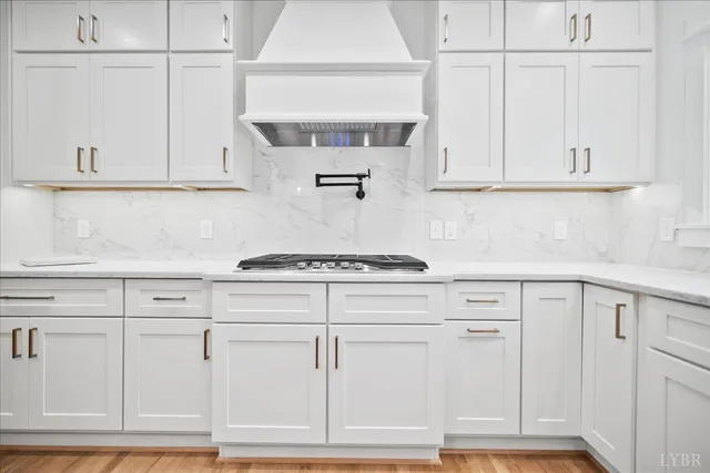 a view of empty room with wooden floor and fireplace