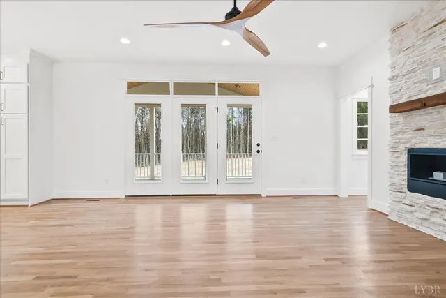 a view of a room with wooden floor