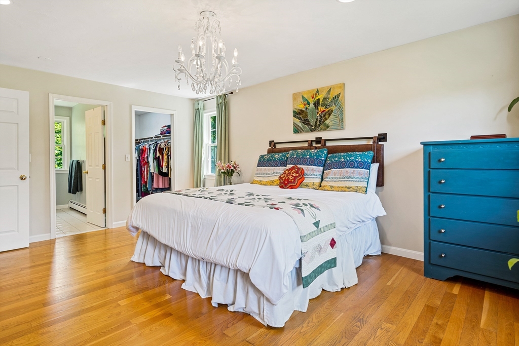 21 Boutwell Road Andover, MA 01810 - Photo 17 of 37 a bedroom with a bed and a chandelier