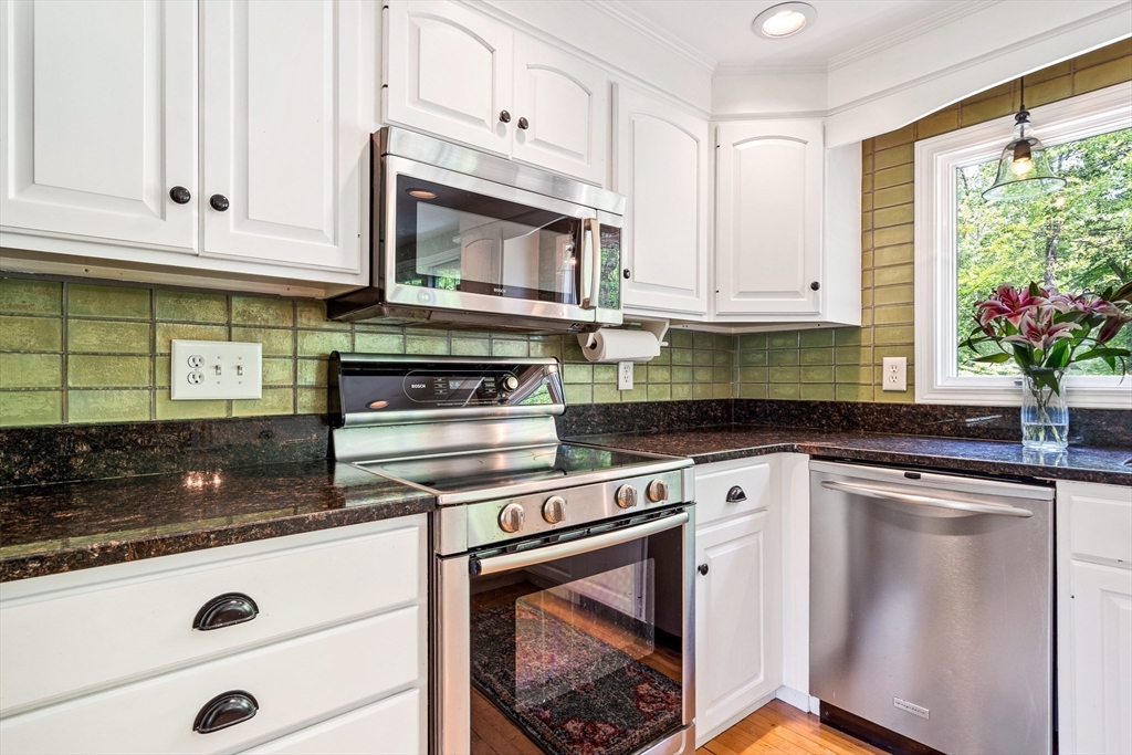 21 Boutwell Road Andover, MA 01810 - Photo 7 of 37 a kitchen with granite countertop white cabinets and white appliances