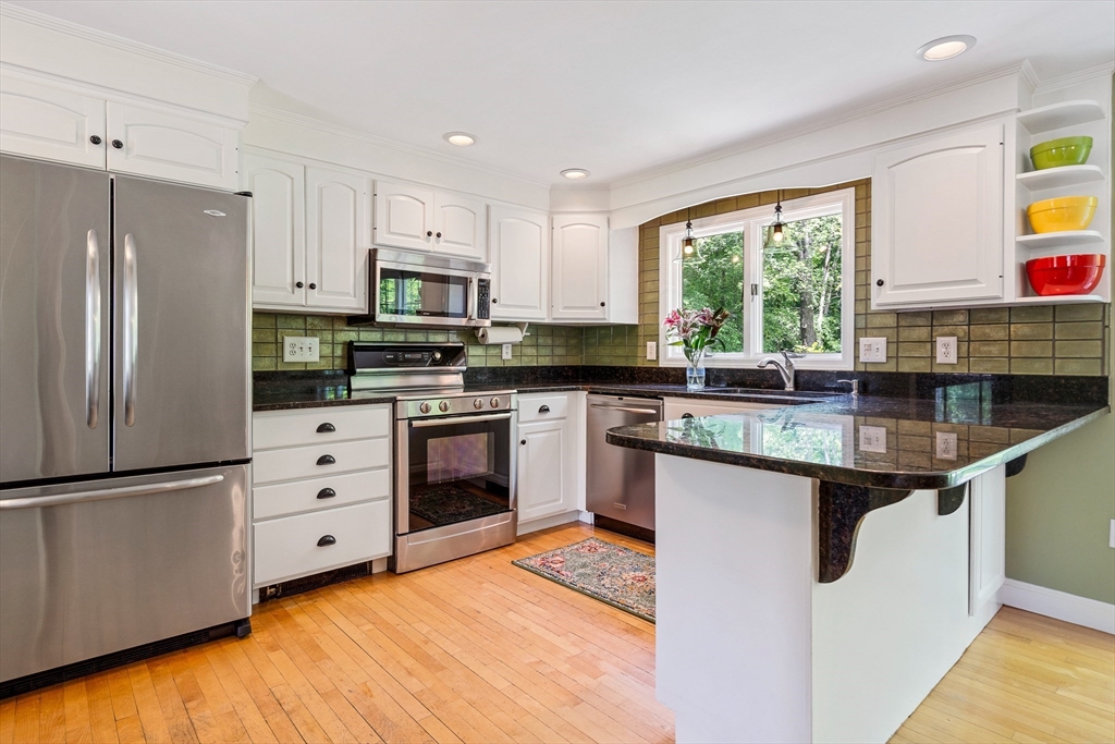 21 Boutwell Road Andover, MA 01810 - Photo 8 of 37 a kitchen with stainless steel appliances granite countertop a sink stove and refrigerator