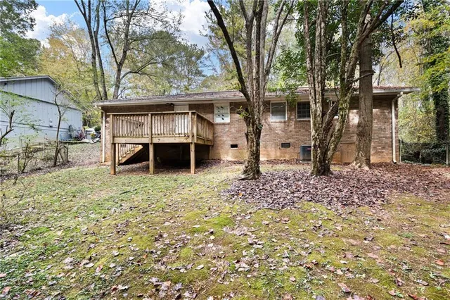 a view of a house with a tree and a yard