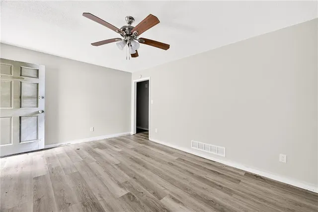 a view of an empty room with wooden floor