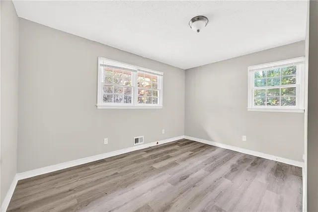 a view of room with hardwood floor and window