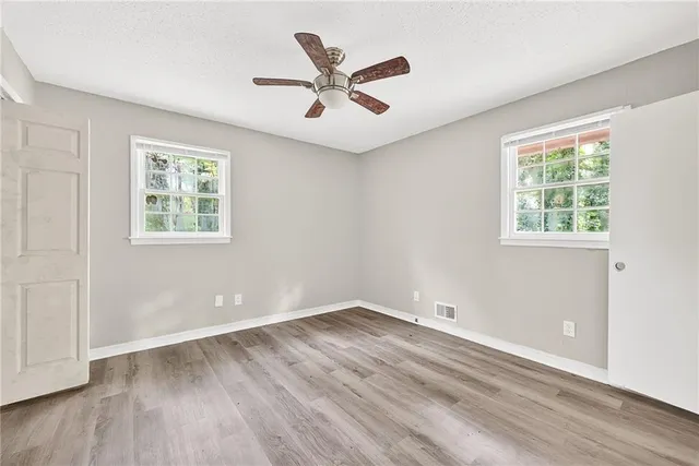 wooden floor in an empty room with a window