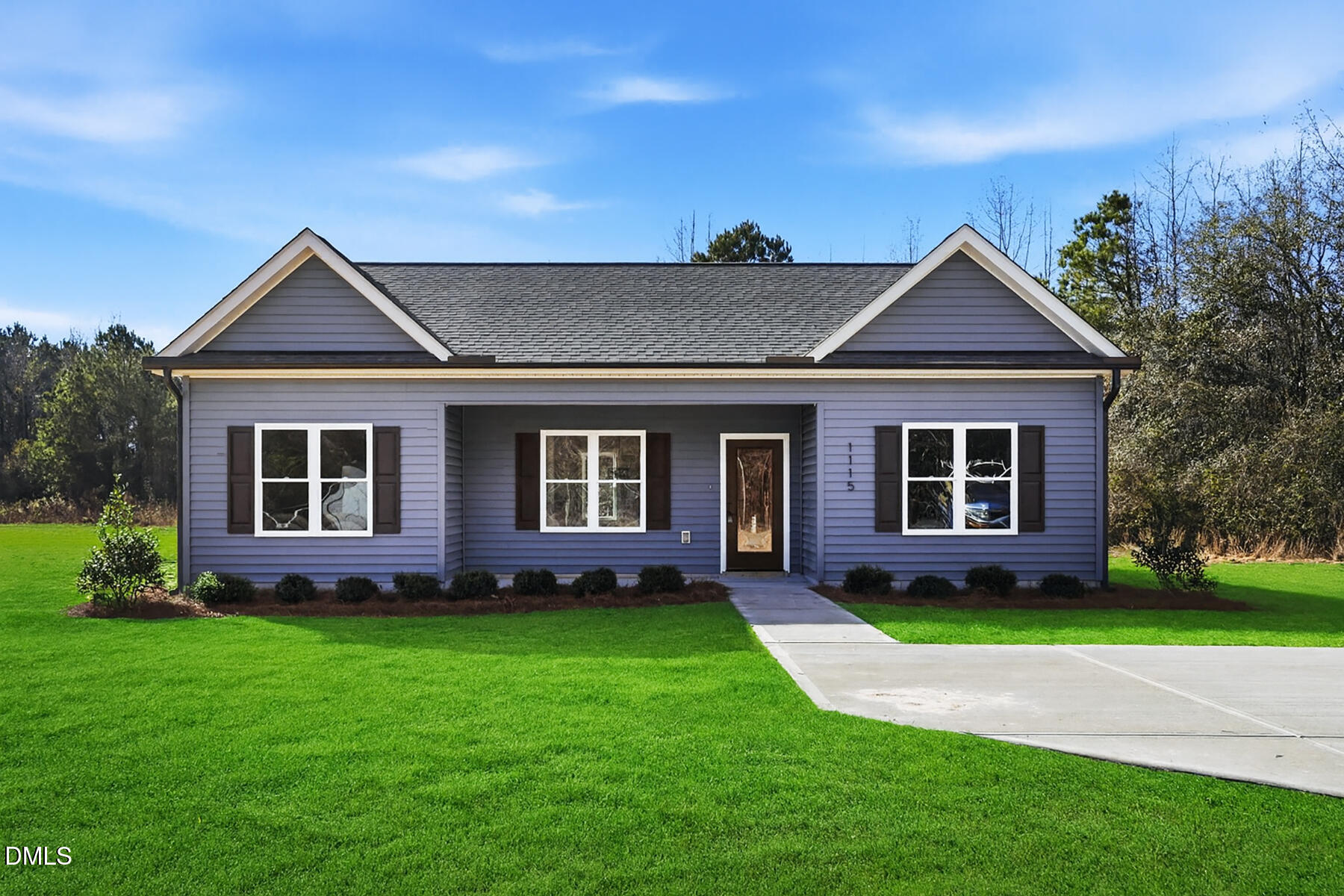 a front view of a house with a yard and potted plants